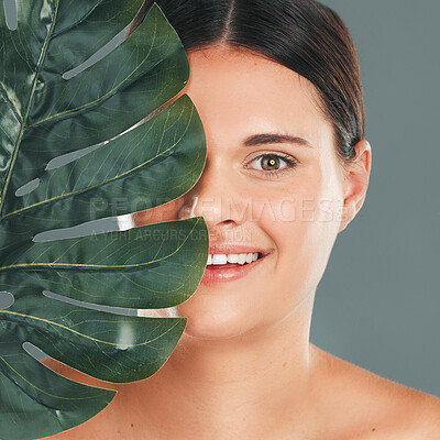 Palm leaf, face and woman in portrait with smile, beauty and skincare with natural cosmetics isolated in studio background. Healthy skin, wellness and glow, facial and eco friendly cosmetic treatment
