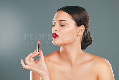 Buy stock photo Lipstick, woman and makeup in studio for skincare, cosmetics and aesthetics. Young model face, red colorful lips and beauty product for luxury fashion, salon and cruelty free facial balm application 