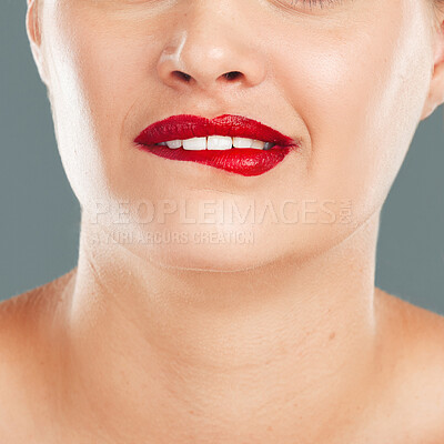 Buy stock photo Woman bite lips with lipstick, face zoom and makeup, flirt with red cosmetics isolated on studio background. Sexy mouth, beauty and skincare with cosmetic wellness and glow, facial and healthy skin