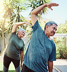 Fitness, yoga and health with a senior couple outdoor in their garden for a workout during retirement. Exercise, pilates and lifestyle with a mature man and woman training together in their backyard