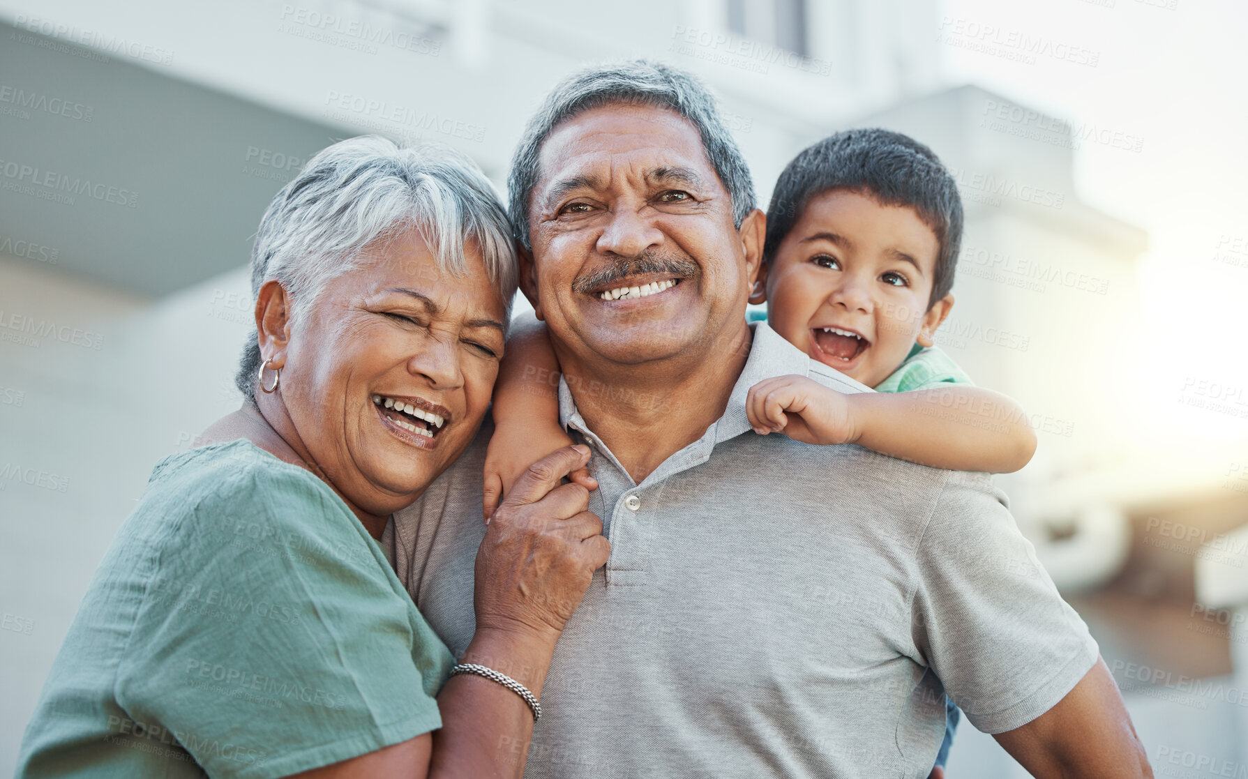 Buy stock photo Grandparents, hug and child with smile for happy holiday or weekend break with elderly people at the house. Portrait of grandma and grandpa holding little boy on back for fun playful summer together