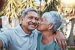 Senior couple, selfie and kiss outdoor portrait with love, happiness and care with a smile in garden. Happy retirement, profile picture and hug of elderly people enjoying life and marriage  