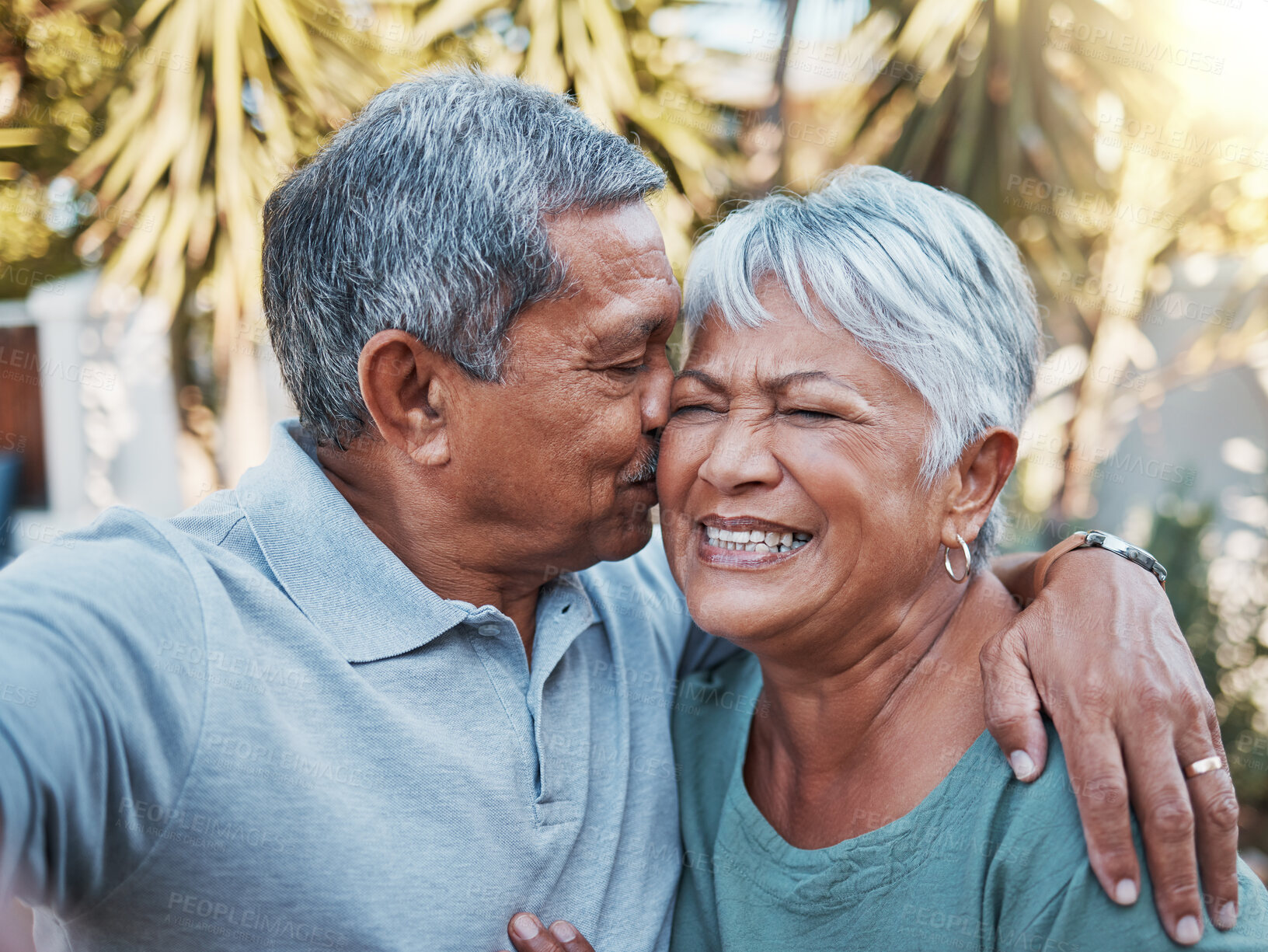 Buy stock photo Love, kiss and happy with selfie of old couple for retirement, smile and affectionate in garden of home. Bonding, happiness and summer with senior man and woman in for romantic, picture and peace