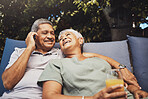 Phone call, outdoor and senior couple relaxing together while on a summer vacation or weekend trip. Happy, love and elderly man and woman resting while on a mobile conversation on retirement holiday.