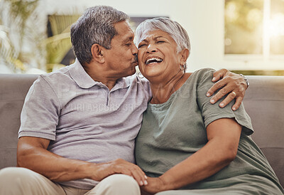 Buy stock photo Happy, senior couple and kiss of elderly woman and man laughing with happiness on a sofa. Living room, couch and marriage support of people in retirement with love and joy together in a house lounge