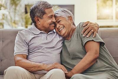 Buy stock photo Happy, love and senior couple on a sofa hugging, bonding and relaxing together in their living room. Happiness, laugh and elderly man and woman pensioners in retirement embracing on a couch at home.