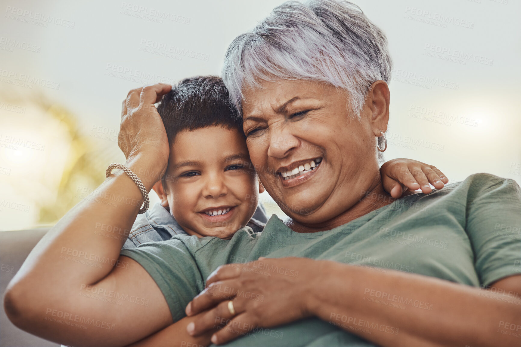 Buy stock photo Happy, grandmother and grandchild on a sofa, smile and laugh, love and family while bonding in their home. Relax, grandma and child embrace, funny and joke on a couch, loving and sweet in living room