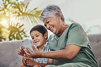 Smartphone, family or grandmother with child for meme, funny or watch online cartoon on mobile app and sofa. Happy, laugh and senior woman with kid on cellphone for comedy video and internet at home