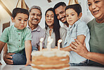 Birthday, family and children with parents and grandparents in a kitchen for cake, celebration and bonding. Party, cake and kids with mother and father, happy and smile with grandmother and grandpa