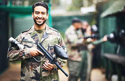 Buy stock photo Paintball, gun and portrait of a man soldier in a camouflage military outfit for extreme sports. Happy, smile and male player in army clothes with a pistol preparing for a match in an outdoor arena.