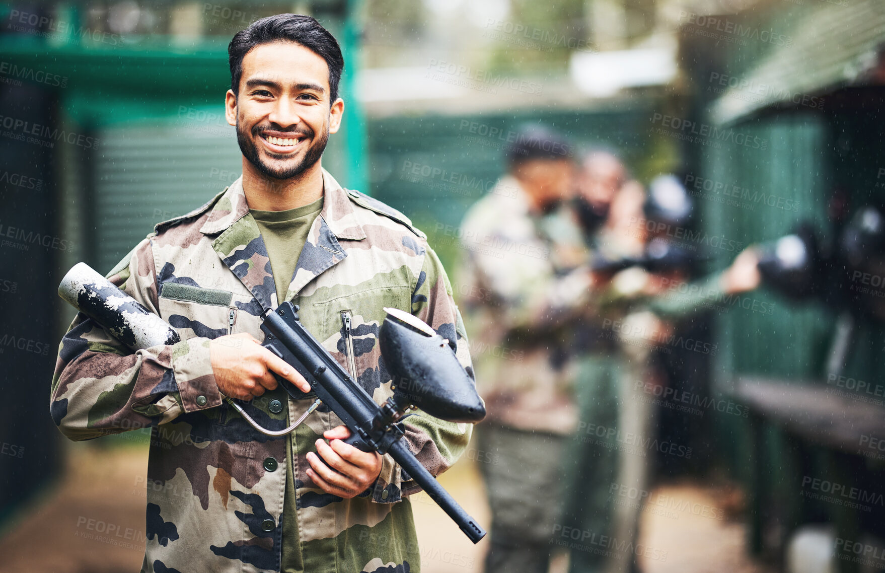 Buy stock photo Paintball, gun and portrait of a man soldier in a camouflage military outfit for extreme sports. Happy, smile and male player in army clothes with a pistol preparing for a match in an outdoor arena.