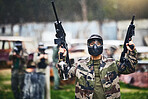 Paintball, gun or man ready for a shooting game with fast action on a fun battlefield on holiday. Mission, man or player with military weapons gear for survival in an outdoor competition playground