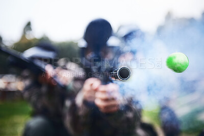 Buy stock photo Paintball, shooting and person with a gun during a game, competition or match on a field. Fire, smoke and tool in motion for attack, battle and aim with a weapon during an outdoor cardio sport