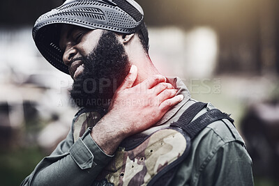 Buy stock photo Man, neck pain and paintball injury holding sore area, joint or inflammation in agony after game or match outdoors. Male soldier player in extreme sport suffering from painful ache or shot during war