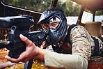 Paintball, gun or soldier in a shooting game with fast action on a fun battlefield on holiday. Military mission, target or focused man with war weapons gear for survival in an outdoor competition