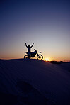 Motorcycle, sport and silhouette of man winner on bike at night for exercise, wellness or workout in nature. Fitness sports, health or motorbike person celebrate on desert dirt sand or hill mountain
