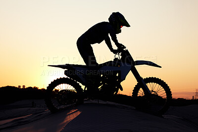Buy stock photo Silhouette, sports and motorcycle riding against sunset, sky and background in nature, extreme sport and adrenaline. Biking, motorbike and person driving on dirt road, sunrise and shadow or freedom