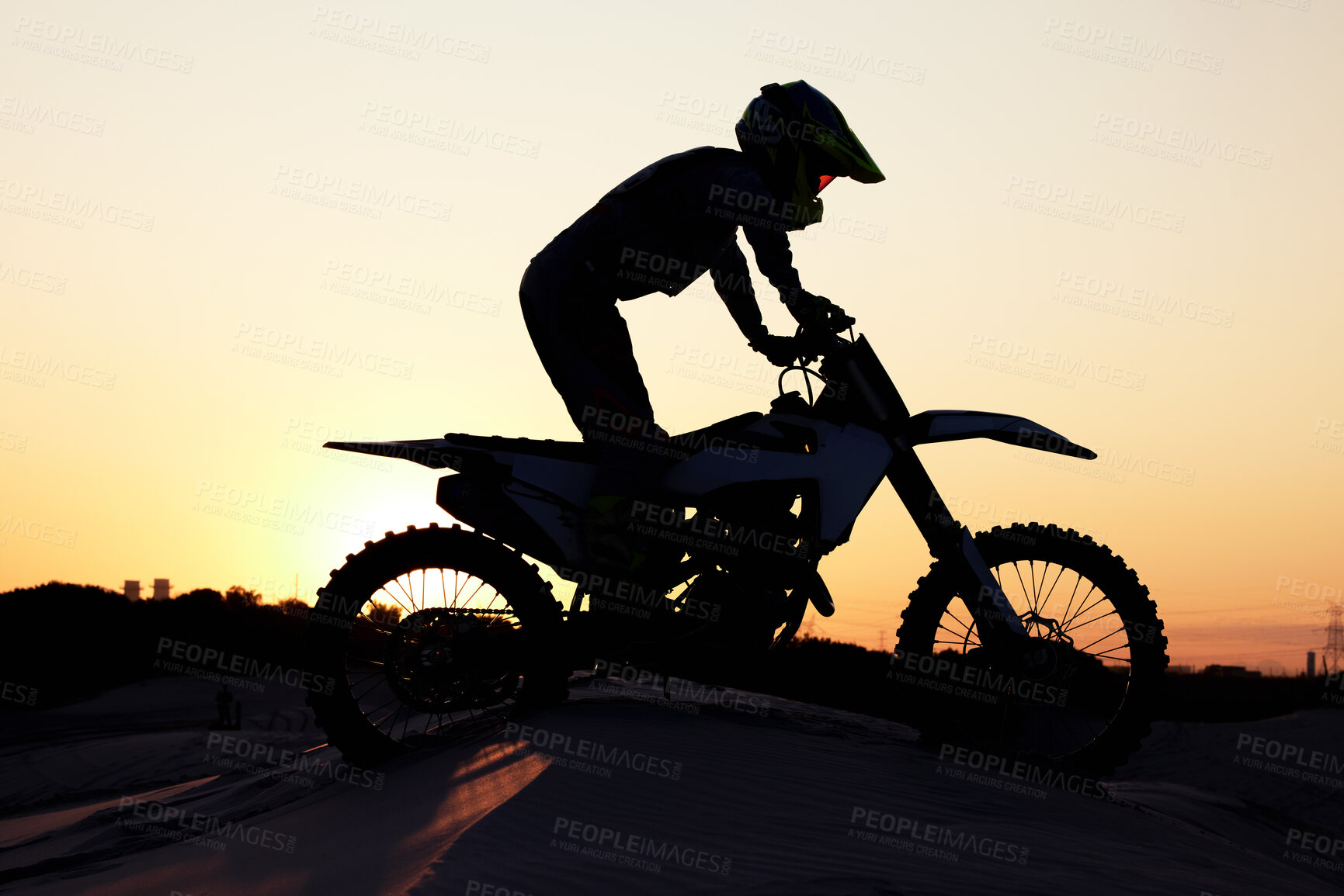 Buy stock photo Silhouette, sports and motorcycle riding against sunset, sky and background in nature, extreme sport and adrenaline. Biking, motorbike and person driving on dirt road, sunrise and shadow or freedom