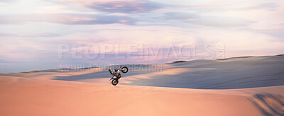 Buy stock photo Desert dunes, moto cross and sports adventure athlete doing a extreme jump with speed. Travel, sand and bike with energy of a man athlete cycling on dirt with challenge and sport race with freedom