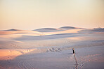 Desert, extreme moto cross and sports adventure athlete doing a jump with speed. Travel, sand and bike with energy of a man athlete cycling on dirt with challenge and sport race with freedom