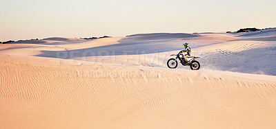Buy stock photo Desert, nature and athlete riding a motorcycle for exercise, fitness or skill training in nature. Extreme sports, action and male athlete on a bike for an outdoor workout in the sand dunes in Dubai.