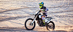 Motorcycle, desert race and extreme sport expert with agile speed, power or balance in nature. Motorbike man, rally and sand on fast vehicle with helmet, safety clothes and motivation for motorsport