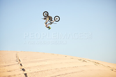 Buy stock photo Motorcycle, jump and sports athlete in desert, dirt bike rally outdoor with extreme sport stunt, power and action. Nature, adventure and freedom, fitness challenge and biker person, mockup and travel