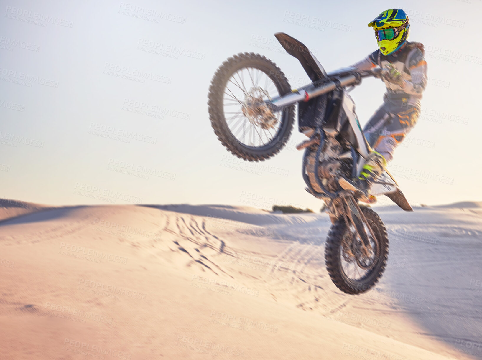 Buy stock photo Motorcycle jump, sports outdoor with exercise in desert, stunt for extreme sport, speed and helmet for safety. Challenge, freedom and athlete biking, fitness mockup and person training with dirt bike