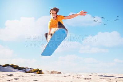 Buy stock photo Sport, sandboard man jumping man in a desert for extreme sports, fitness and training against blue sky background. Sandboarding, jump and guy in dunes with energy, freedom and adrenaline in Dubai
