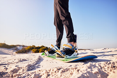 Buy stock photo Sandboard, sports and athlete in the desert sand with hills for exercise, competition or training. Fitness, travel and man on a board in a dune for a workout while on vacation or adventure in Dubai.