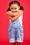 Portrait, hug and girl in studio, happy and smile against red background with mockup. Face, love and caring toddler standing against space, embrace and positive, smiling and self love while isolated