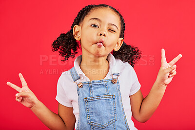 Buy stock photo Happy, peace sign and kiss with portrait of girl for summer, happiness and funny face. Meme, fashion and smile with child and hand sign for youth, comedy and positive in red background studio 