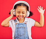 Dancing, child and headphones for music, fun radio and girls podcast on isolated red background and studio. Smile, happy and energy kid listening to dance audio, sound and streaming media on backdrop