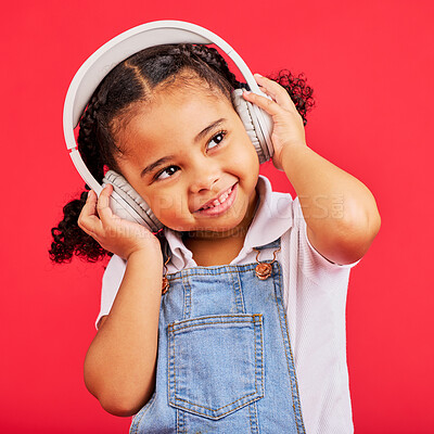 Buy stock photo Happy, kid and headphones for music, radio and fun podcast on isolated red background and dancing studio. Smile, little girl and child listening to dance audio, sound and streaming media on backdrop