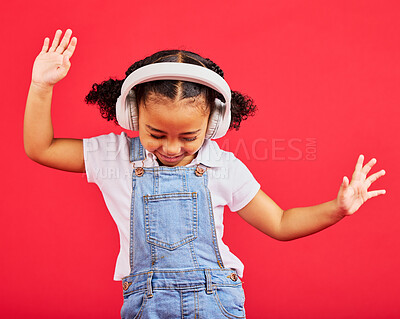 Buy stock photo Dancing, energy and kid and music headphones, fun radio and loud podcast on isolated red background or studio backdrop. Smile, happy child and girl listening to dance audio, sound and streaming media