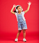Dance, energy or happy kid on music headphones, fun radio or dancing podcast with hands up on red background. Smile, girl or dancer child listening to audio, streaming sound or media on studio mockup