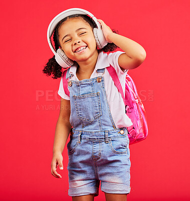 Buy stock photo Student, child or headphones for music, school podcast or education radio in nursery song, sound or learning audio. Smile, happy or kid listening to fun studying media with backpack on red background