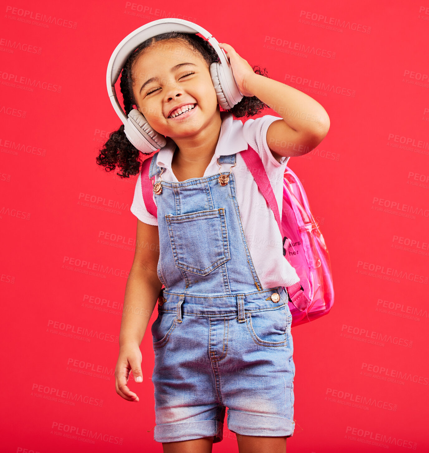 Buy stock photo Student, child or headphones for music, school podcast or education radio in nursery song, sound or learning audio. Smile, happy or kid listening to fun studying media with backpack on red background