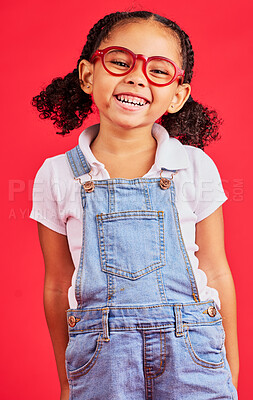 Buy stock photo Happy child, portrait or fashion glasses on red background in children style, eyes care or wellness health. Smile, kid or little girl and optometry frames for cool vision support or medical insurance