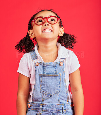 Buy stock photo Looking up, child and fashion glasses on red background in kids style, eyes care and wellness health insurance. Smile, happy and little girl with optometry frames, vision support or retail sales deal