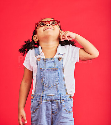 Buy stock photo Looking up, thinking or child and fashion glasses on red background in vision, optician or eyesight sales deal. Smile, happy or little girl and optometry frames, ideas or decision choice of promotion