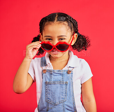Buy stock photo Child portrait, fashion and glasses on isolated red background in summer trend, holiday style and cool vacation. Smile, happy and kid with sunglasses for eyes healthcare, wellness and sun protection