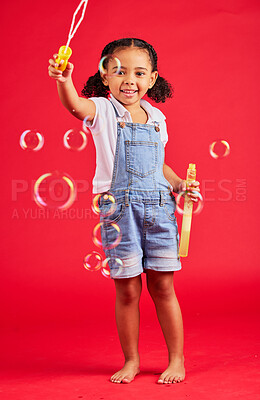 Buy stock photo Child, portrait or bubbles playing on isolated red background in hand eye coordination, kids activity or fun game. Smile, happy or little girl and soap wand, studio toy or breathing development skill