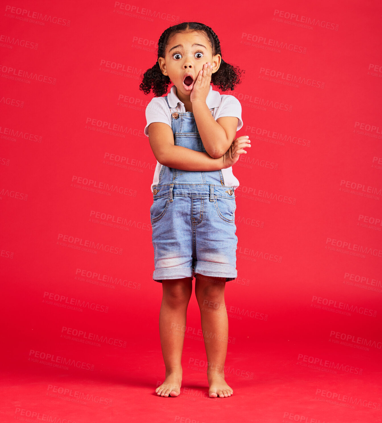 Buy stock photo Little girl, portrait or shocked hand on face, isolated or red background and kids gossip, bad news or scary children story. Surprised, anxiety or scared kid in horror facial expression, wow or emoji