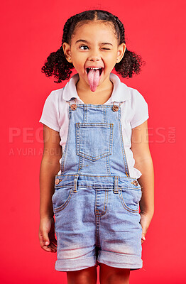 Buy stock photo Child, face and tongue out on isolated red background in goofy, silly games and playful facial expression. Happy, kid and funny little girl with comic, emoji and winking charades in studio activity