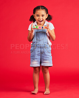 Buy stock photo Learn blocks, education and portrait of child on red background for learning, reading and kindergarten. Child development, knowledge and excited, happy and young girl smile with letters on wood toys