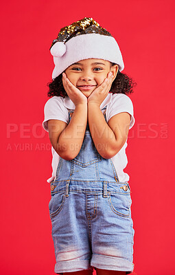 Buy stock photo Little girl, face and portrait smile for Christmas, celebration or surprise isolated on a red studio background. Happy child smiling in happiness with hands looking adorable for festive season gift