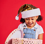 Wow, christmas and gift with a black girl on a red background in studio for festive celebration or surprise. Box, present or kids with a happy female child celebrating a holiday tradition in december