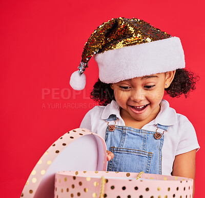 Buy stock photo Wow, christmas and gift with a black girl on a red background in studio for festive celebration or surprise. Box, present or kids with a happy female child celebrating a holiday tradition in december