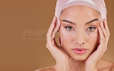 Buy stock photo Woman, muslim and studio portrait for beauty, makeup and wellness with hands on face by background. Islamic model, natural skin glow and hijab with cosmetic health, soft aesthetic or healthy skincare